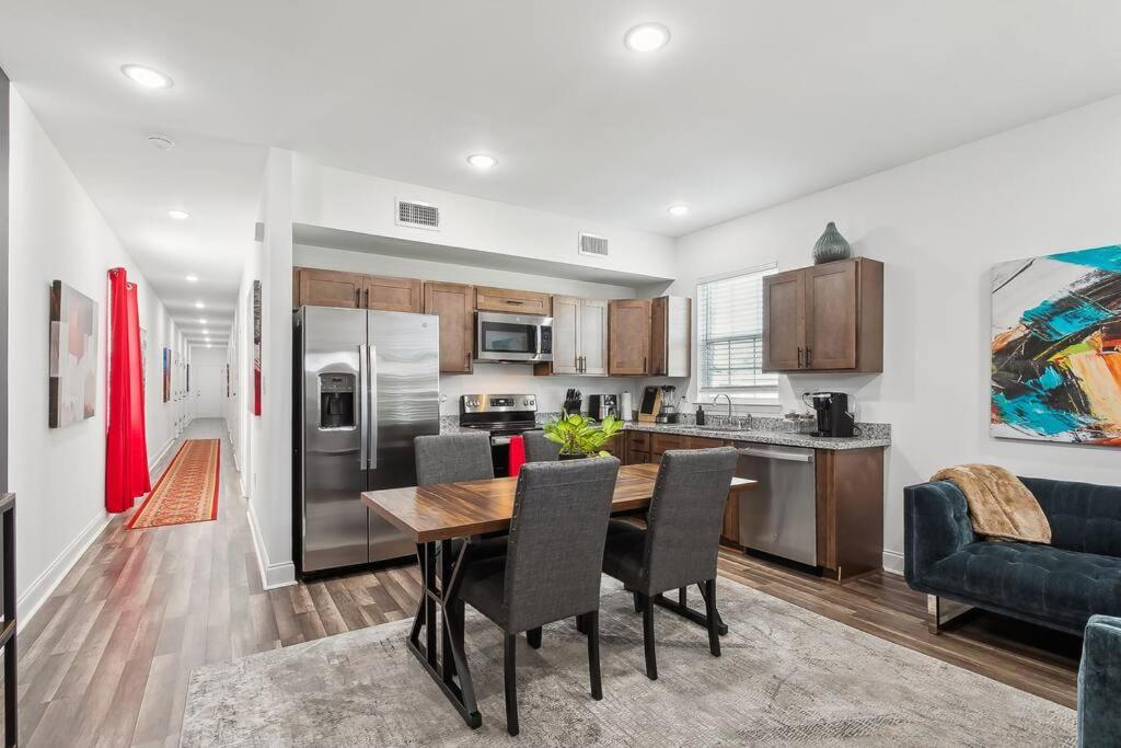 a kitchen and dining room with a table and chairs at Chic 5BR Oasis in NOLA's Heart in New Orleans