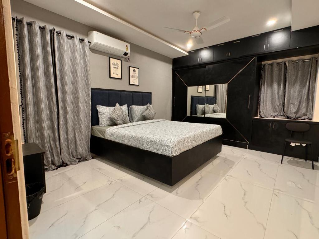 a bedroom with a bed with a black headboard at PRIVATE Luxury Homestay in Khammam in Khammam