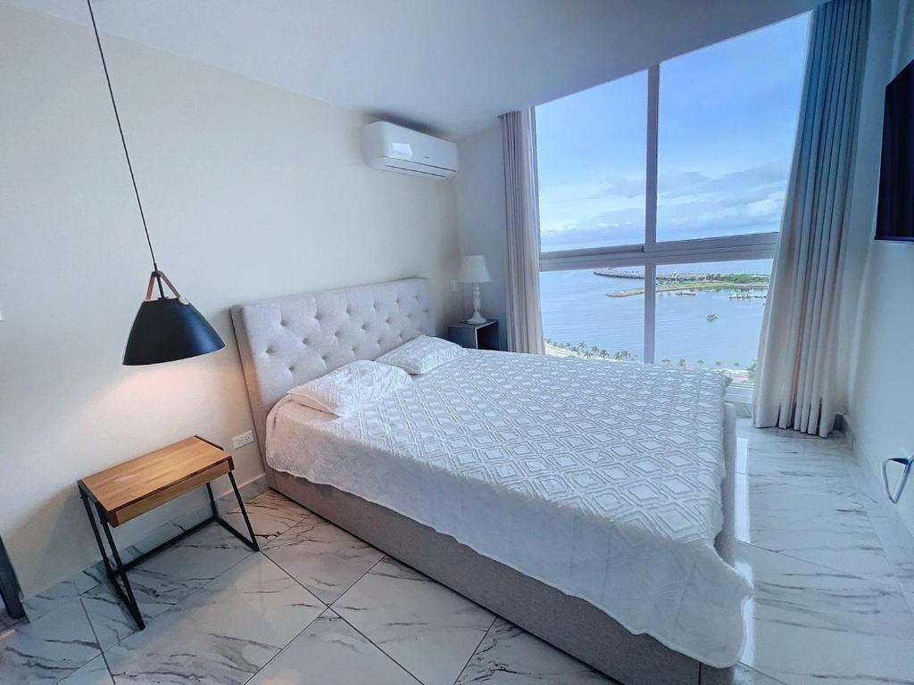 a bedroom with a bed and a view of the ocean at Island Escape Properties 01 in Panama City