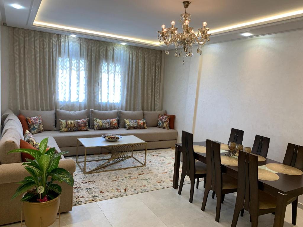 Appartement moderne avec vue panoramique في أغادير: غرفة معيشة مع أريكة وطاولة