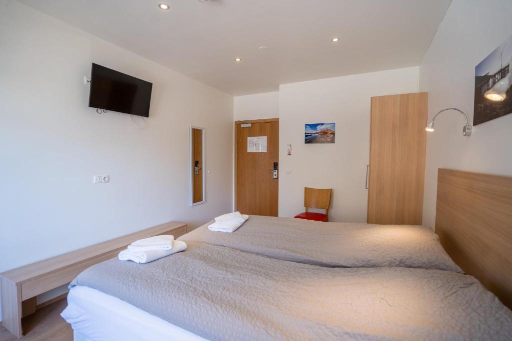 Postel nebo postele na pokoji v ubytování Hotel Eskifjörður