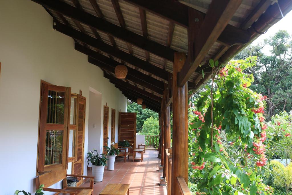 an outdoor porch with a wooden pergola at La Mer Resort, Phú Quốc in Phú Quốc
