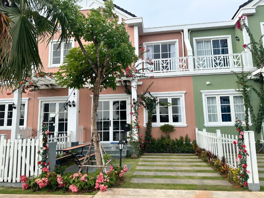 a pink house with flowers in front of it at IVY House in Bình Tú