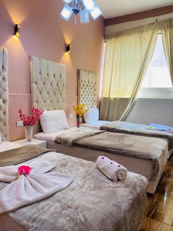 Postel nebo postele na pokoji v ubytování New Palace