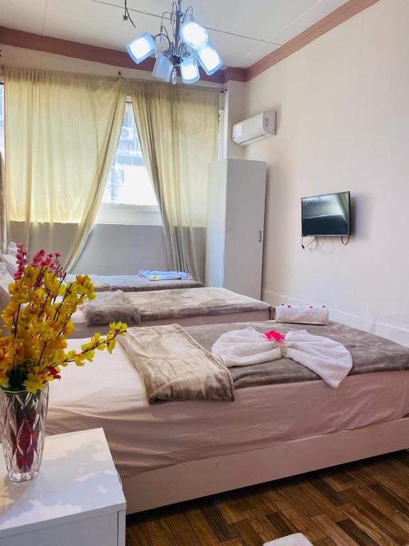 Postel nebo postele na pokoji v ubytování New Palace