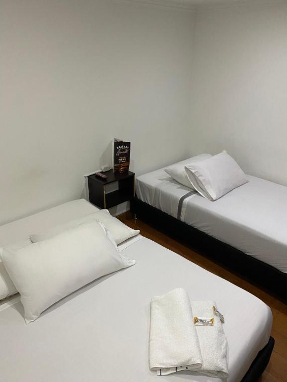 Postel nebo postele na pokoji v ubytování Hotel Quintas de Bogotá