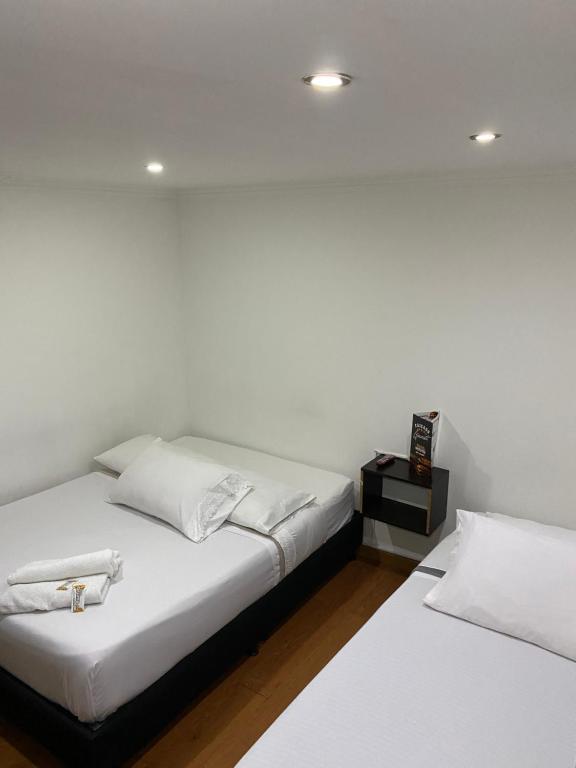 Postel nebo postele na pokoji v ubytování Hotel Quintas de Bogotá