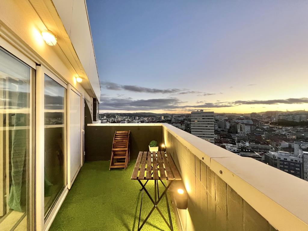 a balcony with a table and a view of a city at Skyline Coruña in A Coruña