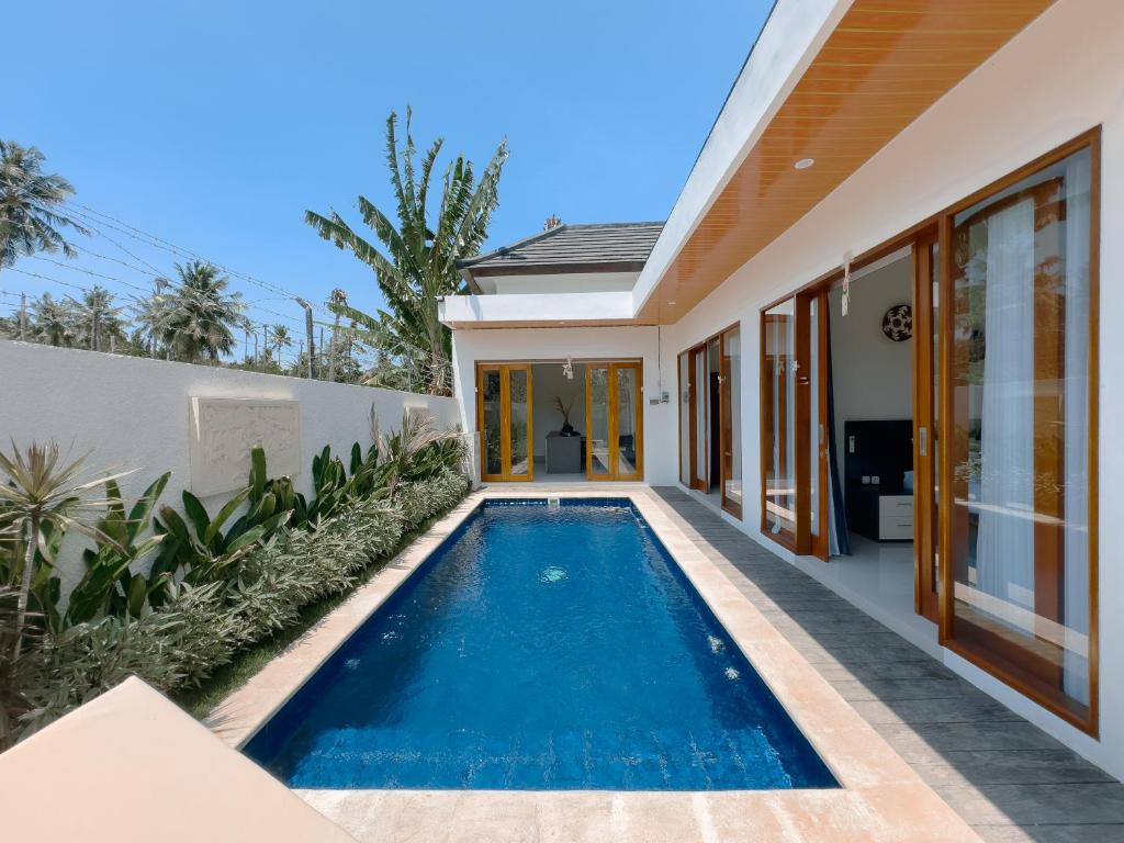 a swimming pool in the backyard of a house at The Arya Villa Lovina in Lovina