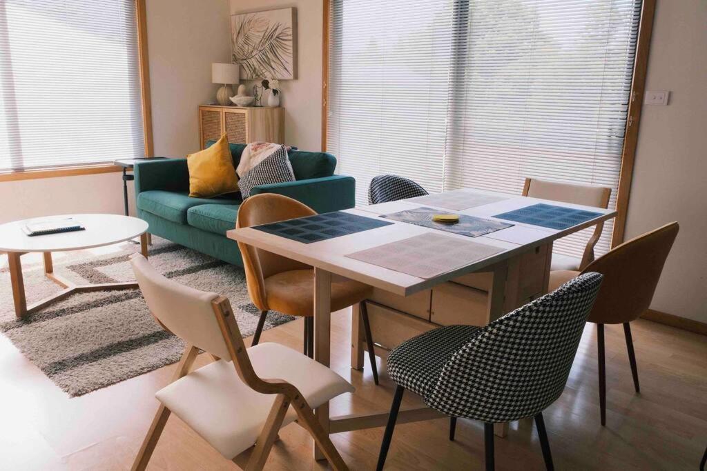 a living room with a table and chairs and a couch at Inner city hotspot & quiet house in Hobart