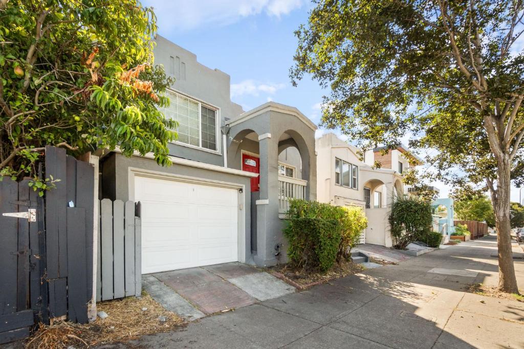 a house with a white garage in a street at The Berkeley Haven in Berkeley