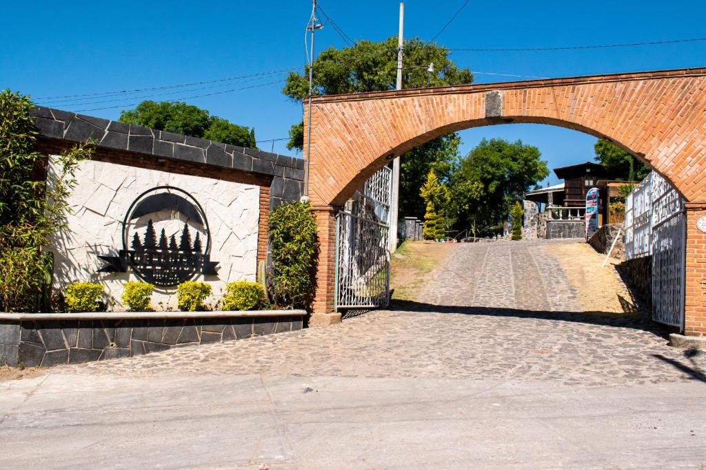 a brick bridge with an arch over a road at Hotel Buenavista in Jocotitlán