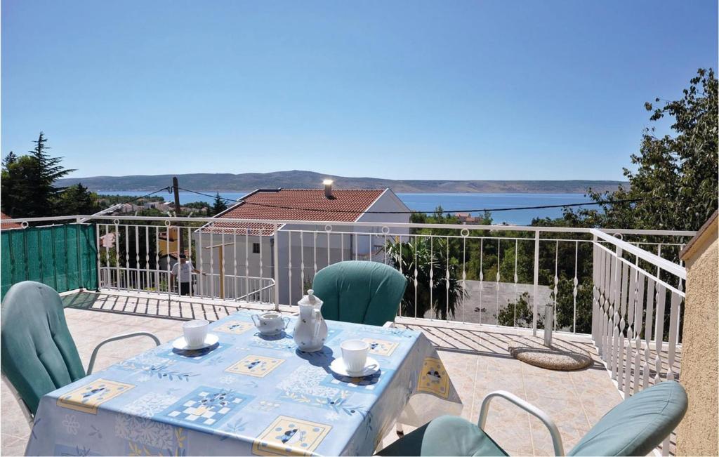 a table and chairs on a balcony with a view of the water at Apartment Alojzija Stepinca Iii in Starigrad-Paklenica