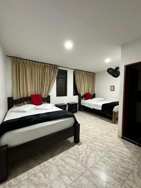 Postel nebo postele na pokoji v ubytování Hotel Plaza Real Pereira