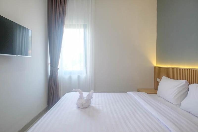 Postel nebo postele na pokoji v ubytování Upcity Hotel Simpang Lima By Sajiwa