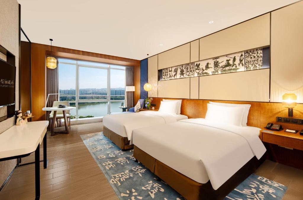 Postel nebo postele na pokoji v ubytování Hisilk Artwork Center Fliport Coso Hotel