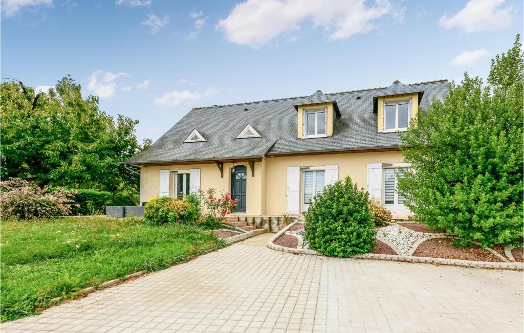 a yellow house with a gray roof and a driveway at Gorgeous Home In Joué Les Tours in Joue-les-Tours