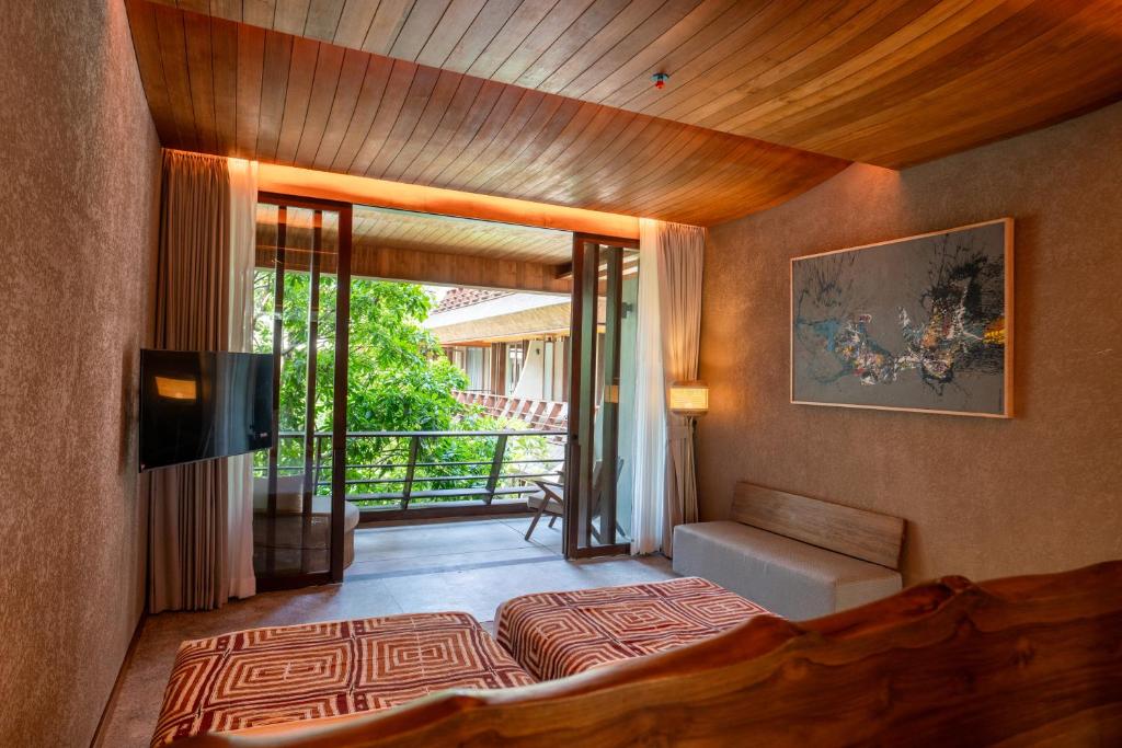 Postel nebo postele na pokoji v ubytování The Kemilau Ubud