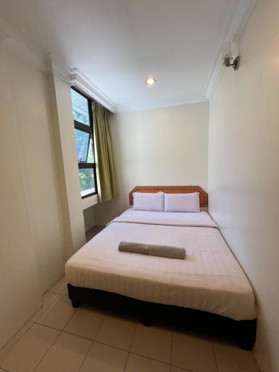 Postel nebo postele na pokoji v ubytování Hotel dan Restoran Seri Kangsar