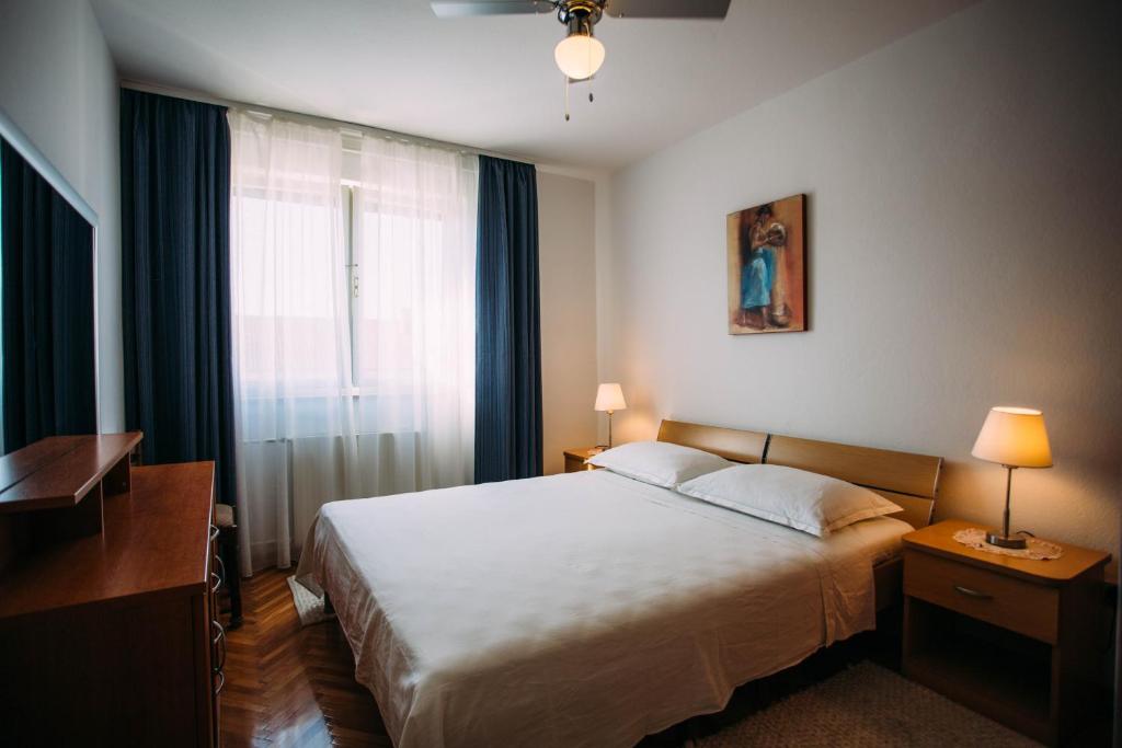Postel nebo postele na pokoji v ubytování Apartments Ivana
