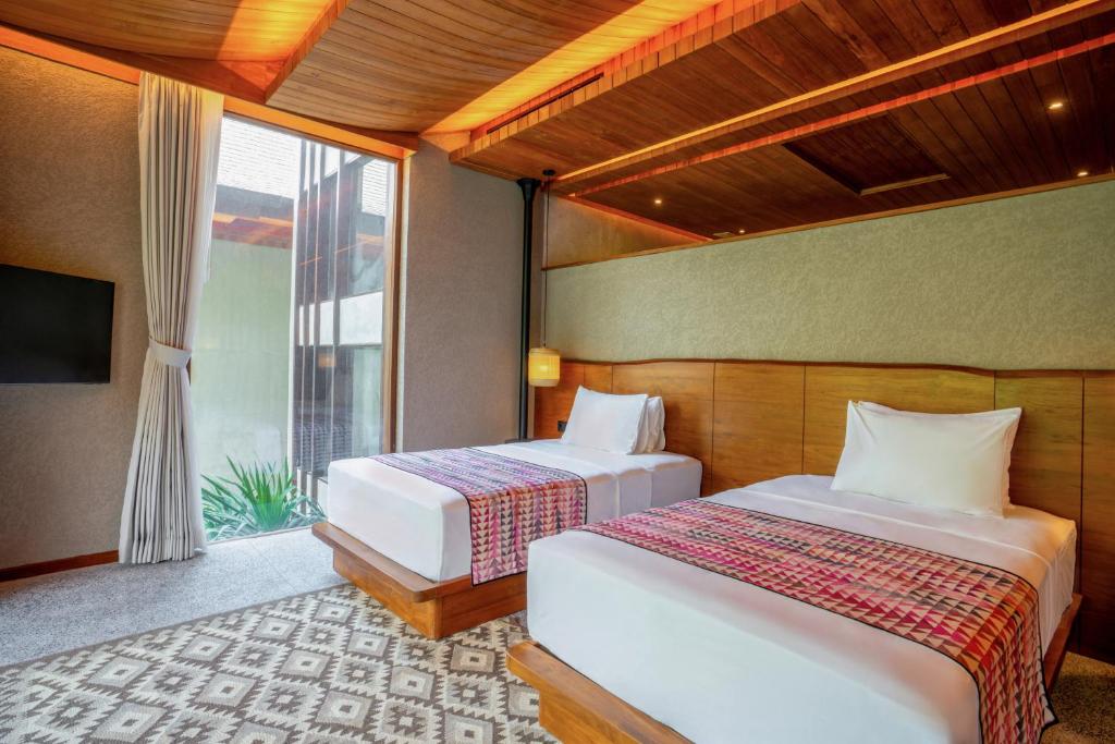 Postel nebo postele na pokoji v ubytování The Kemilau Ubud