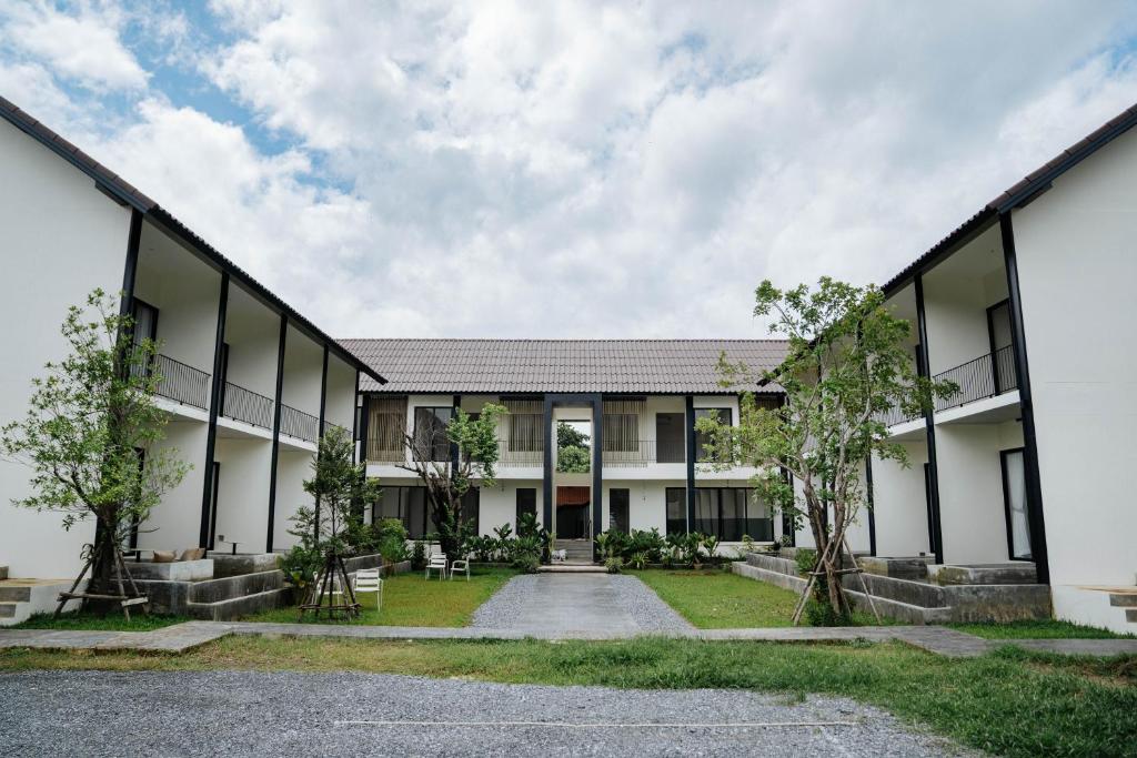 an external view of a building with trees in front at Shanti-Retreat Hotel in Pua