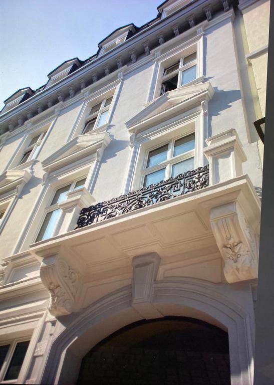 a white building with a balcony on the side of it at FeWo Wohlleben Petrus VI in Trier