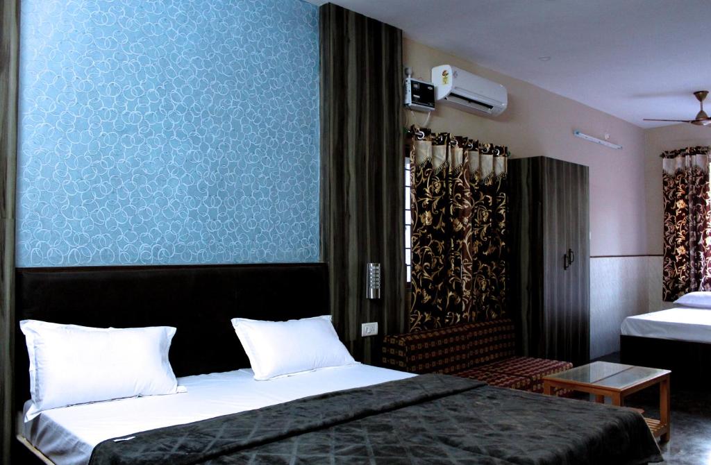 Letto o letti in una camera di Vinodhara Guest House