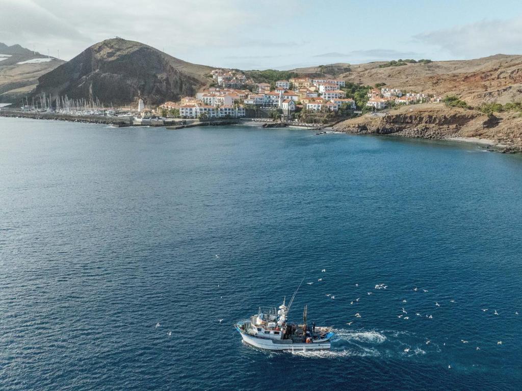 a boat in a large body of water at Dreams Madeira Resort Spa & Marina in Caniçal