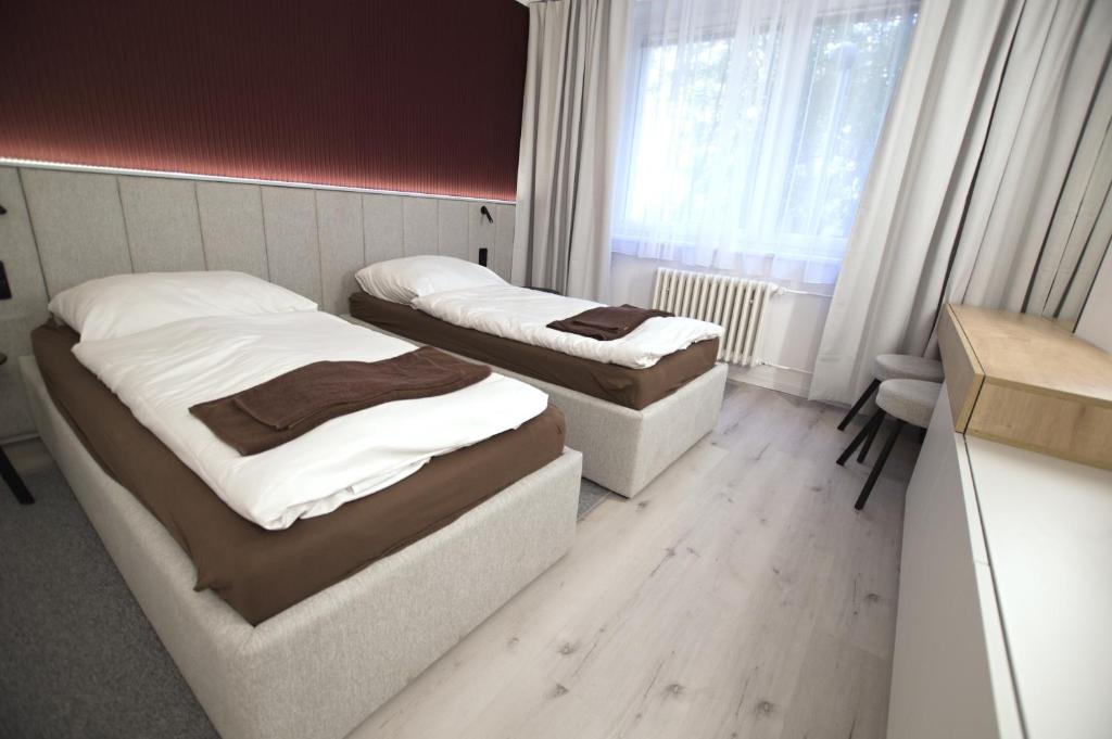 Postel nebo postele na pokoji v ubytování Koleje J.A.Komenského