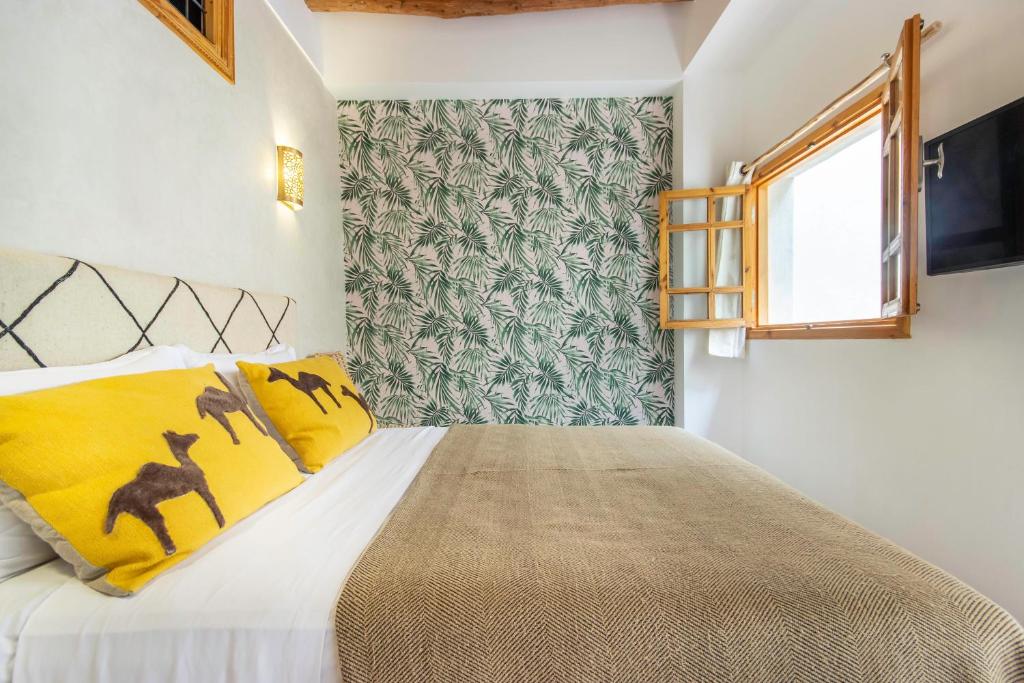Postel nebo postele na pokoji v ubytování Riad Les Suites Marrakech