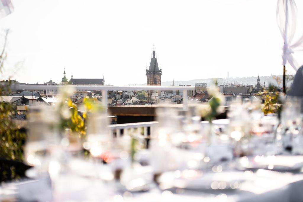 a view of a city skyline from a restaurant with tables at Pytloun Boutique Hotel Prague in Prague
