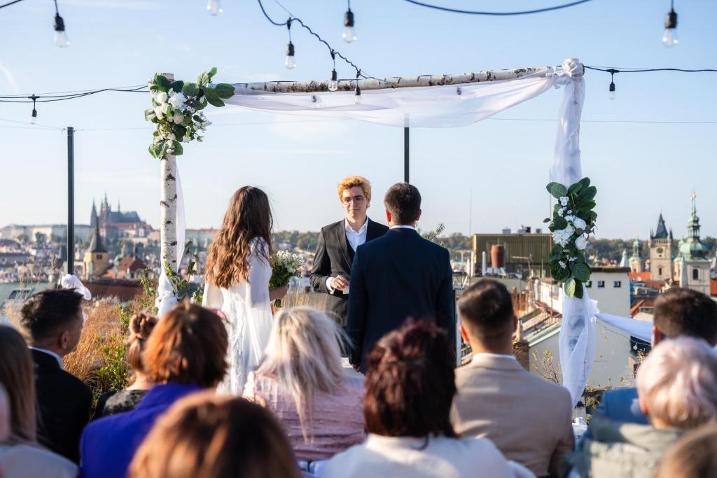 a bride and groom walking down the aisle at their wedding ceremony at Pytloun Boutique Hotel Prague in Prague