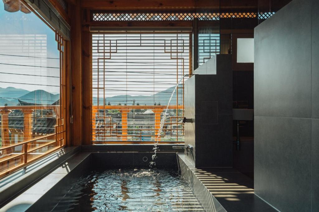 eine Badewanne mit Stadtblick in der Unterkunft Hanok Stay Seowa in Gyeongju