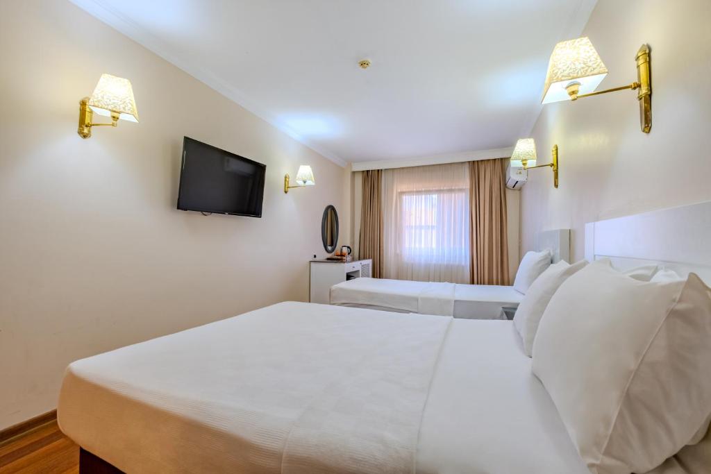 A bed or beds in a room at Peak Star Hotel