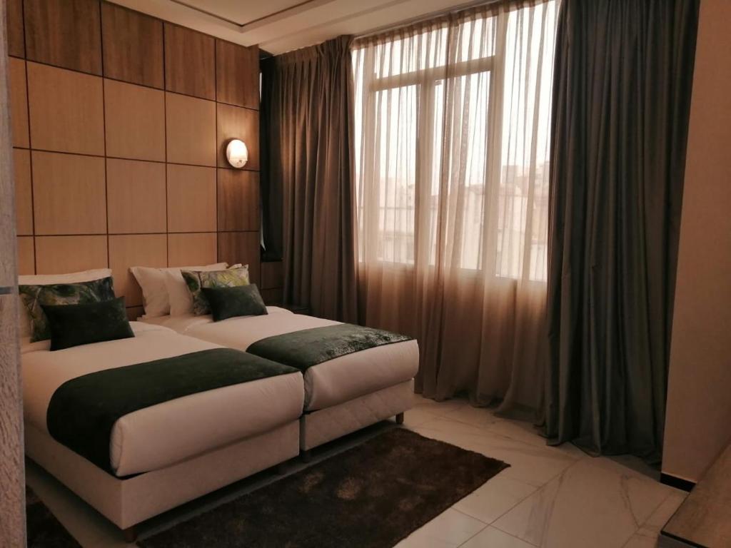 Postel nebo postele na pokoji v ubytování Hôtel Volubilis Meknès