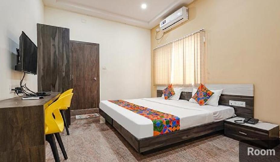 ein Schlafzimmer mit Bett, Schreibtisch und Fernseher in der Unterkunft Lutino Homes Ramurthynagar main Road opposite D Mart in Bangalore