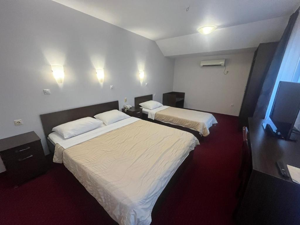 Postel nebo postele na pokoji v ubytování Hotel Elegance