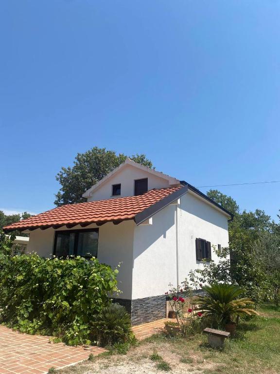 a small white house with a red roof at Villa SHU in Krimovice