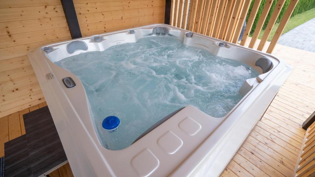 a jacuzzi tub sitting on a wooden floor at Biały Domek Kazimierz Dolny in Kazimierz Dolny