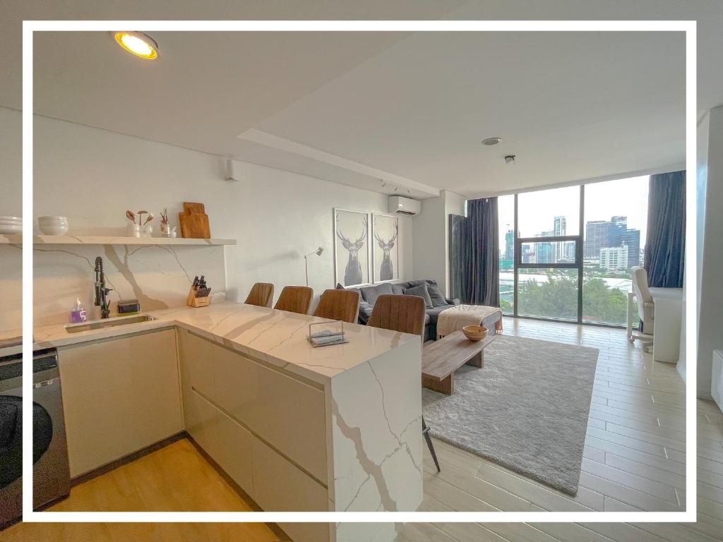 a kitchen and living room with a table and chairs at Premier Suites- Panoramic View in Cebu City