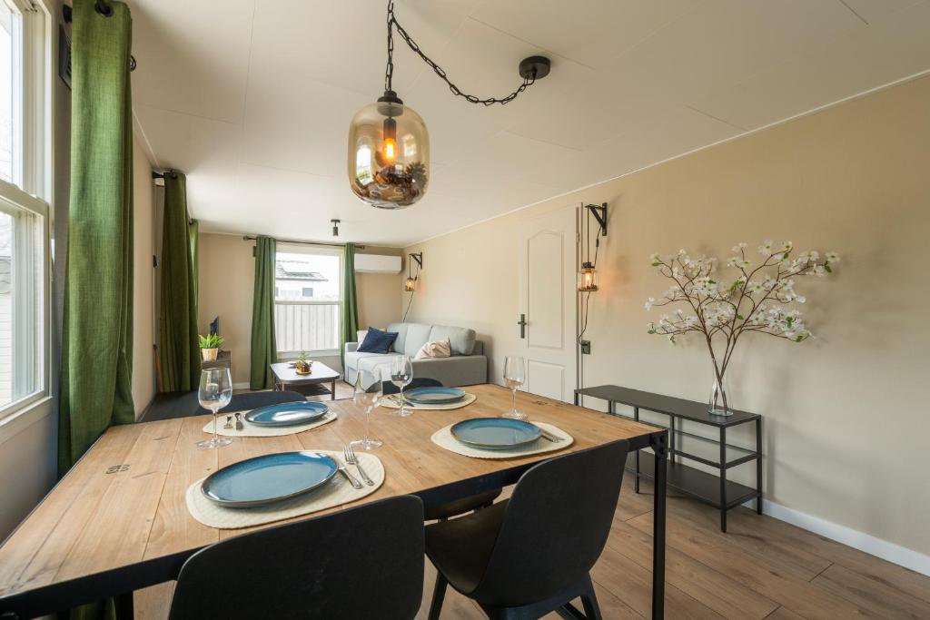 a dining room and living room with a table and chairs at 49, Efteling - Beekse Bergen - Dog Friendly in Oisterwijk