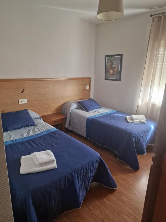 Postel nebo postele na pokoji v ubytování HOSTAL ALTO PÁRAMO