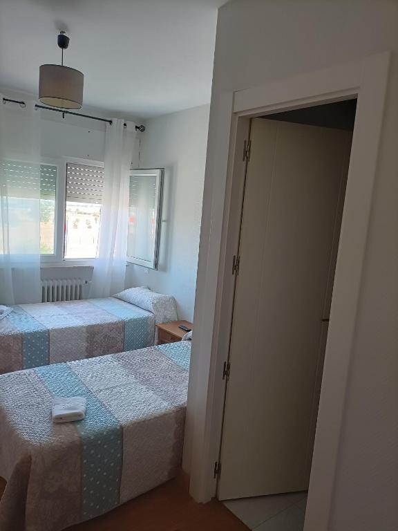 Postel nebo postele na pokoji v ubytování HOSTAL ALTO PÁRAMO