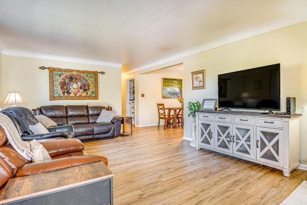 a living room with a couch and a flat screen tv at about 10 Mi to Dtwn Indianapolis Home with Game Room! in Indianapolis