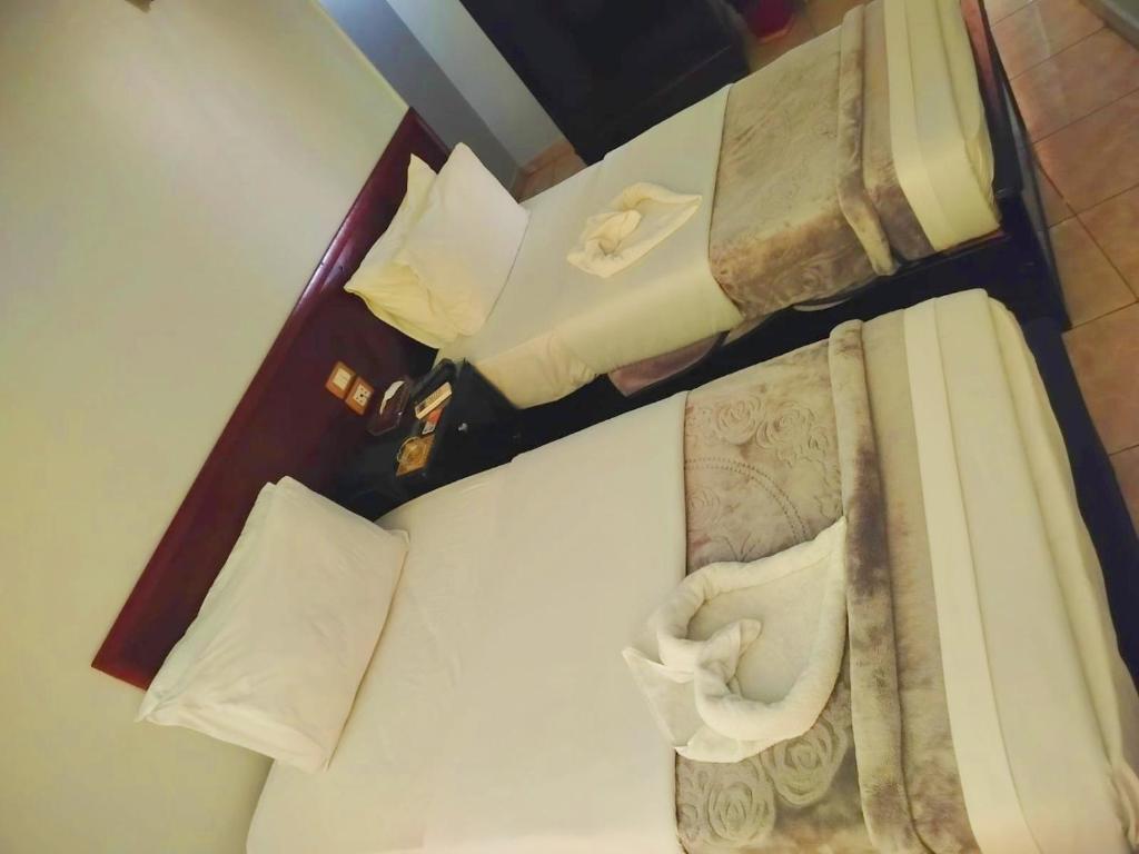Postel nebo postele na pokoji v ubytování Abo Elwafa Hotel