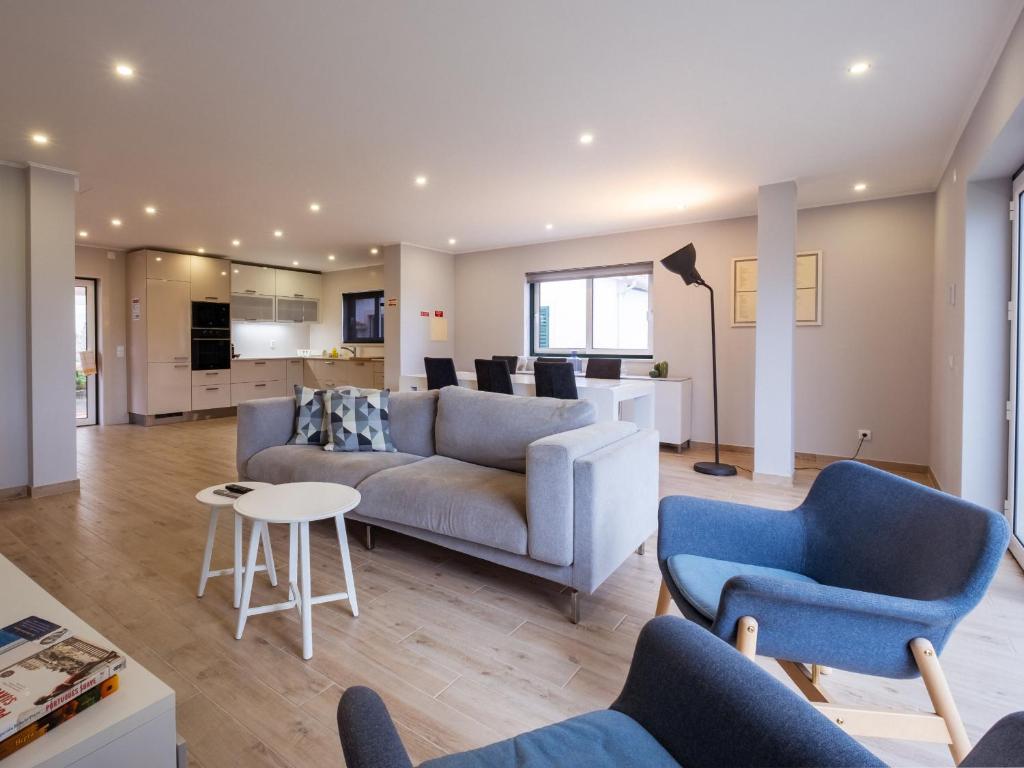 a living room with a couch and two chairs at A Casa do Castelo in Óbidos
