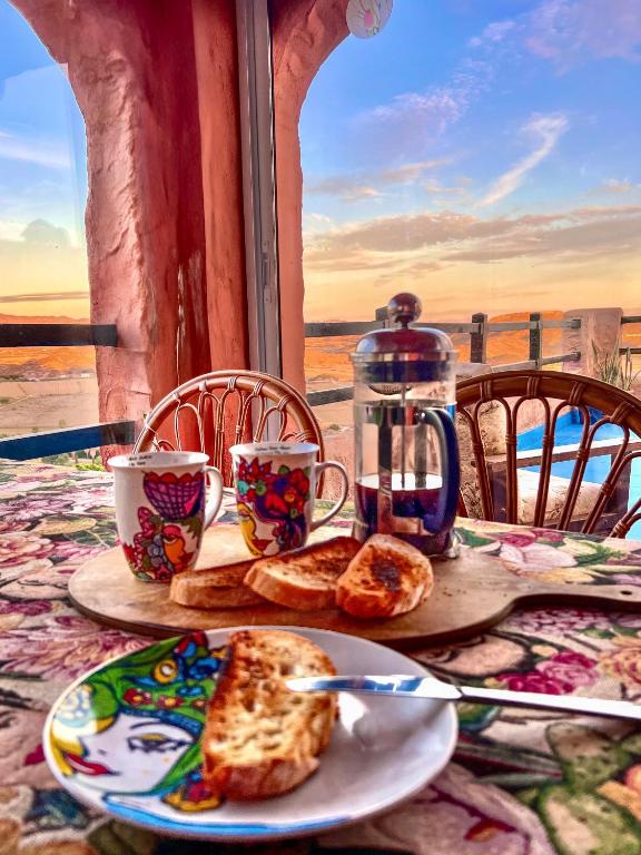 a table with a plate of bread and cups of coffee at Casa Del Arte in Mojácar