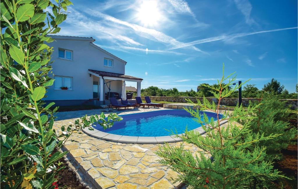 a swimming pool in front of a house at Holiday Home Drinovci With A Fireplace 444 in Drinovci