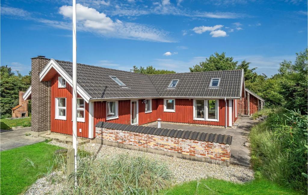 a red house with a gray roof at Amazing Home In Skjern With Kitchen in Skjern